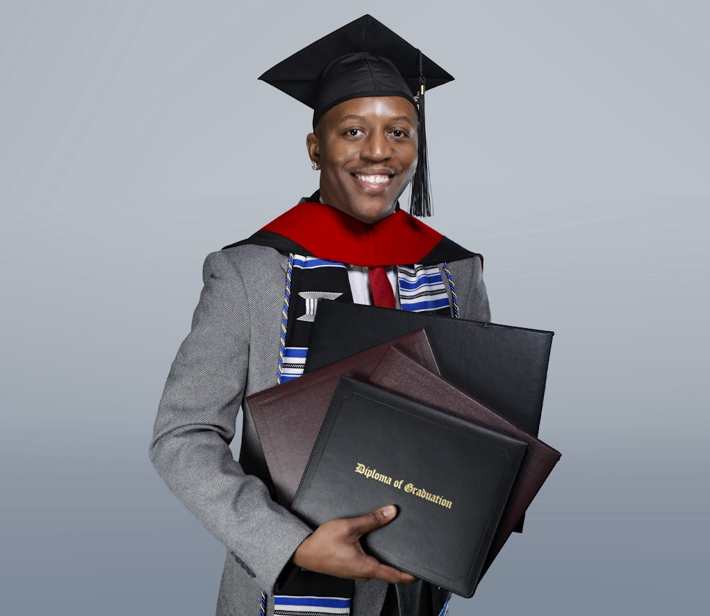 Graduate holding diplomas